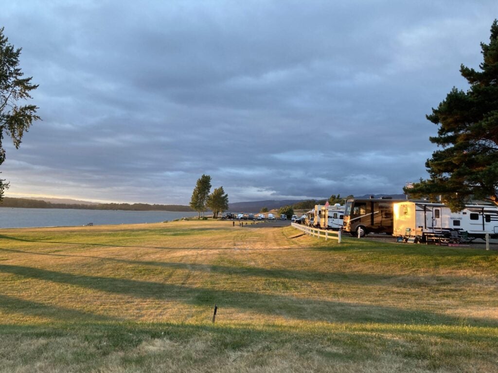 Waterfront RV campground in Washington state with grassy campsites and scenic views along Puget Sound, ideal for coastal RV camping