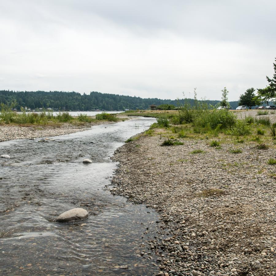 Belfair Creek flowing into Hood Canal with rocky shoreline and coastal scenery, featured as a scenic stop near the best RV campgrounds around Puget Sound for Summer 2026 adventures.