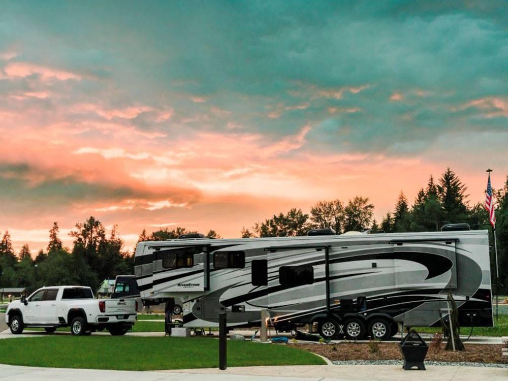 Luxury fifth wheel RV parked at an RV resort during sunset, showcasing proper towing setup and destination camping featured in the RV Towing 101 guide.
