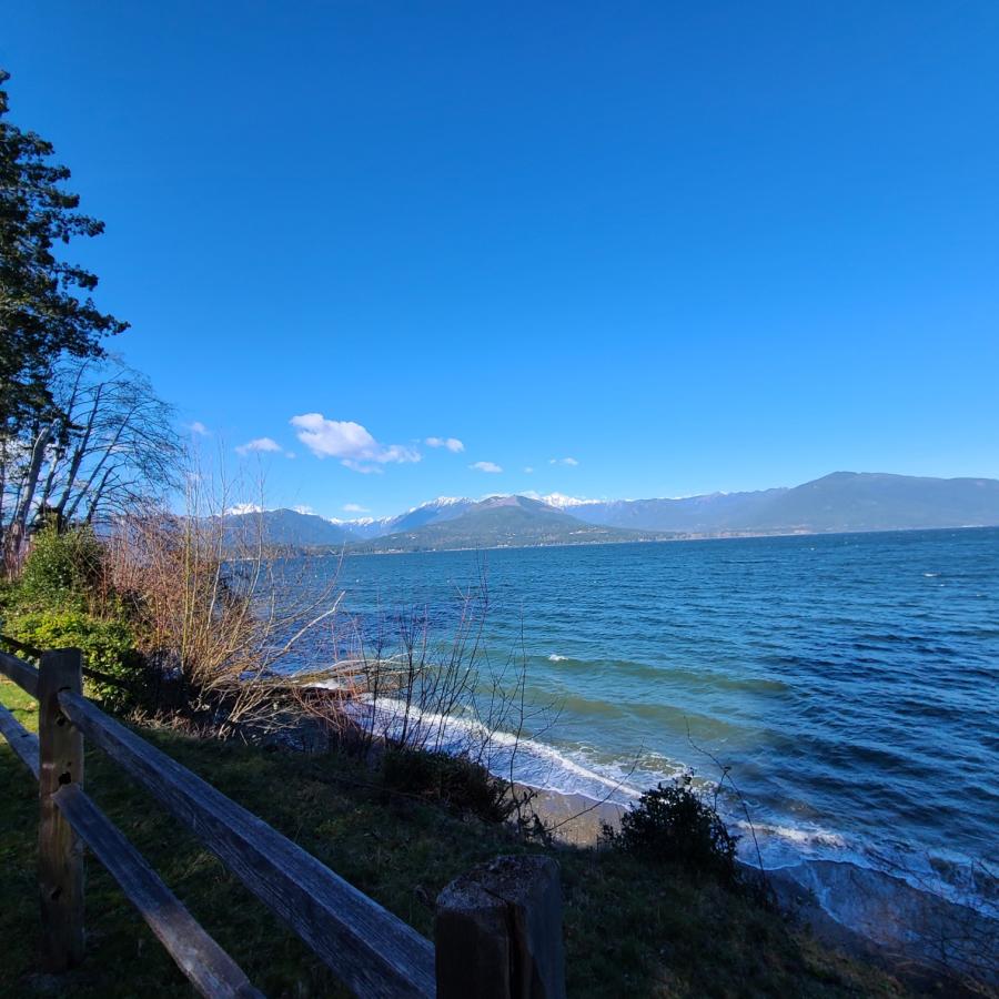 Scenic waterfront views along the shoreline at Scenic Beach State Park near Puget Sound, featuring mountain views, coastal scenery, and peaceful RV camping destinations for Summer 2026 in Washington State.