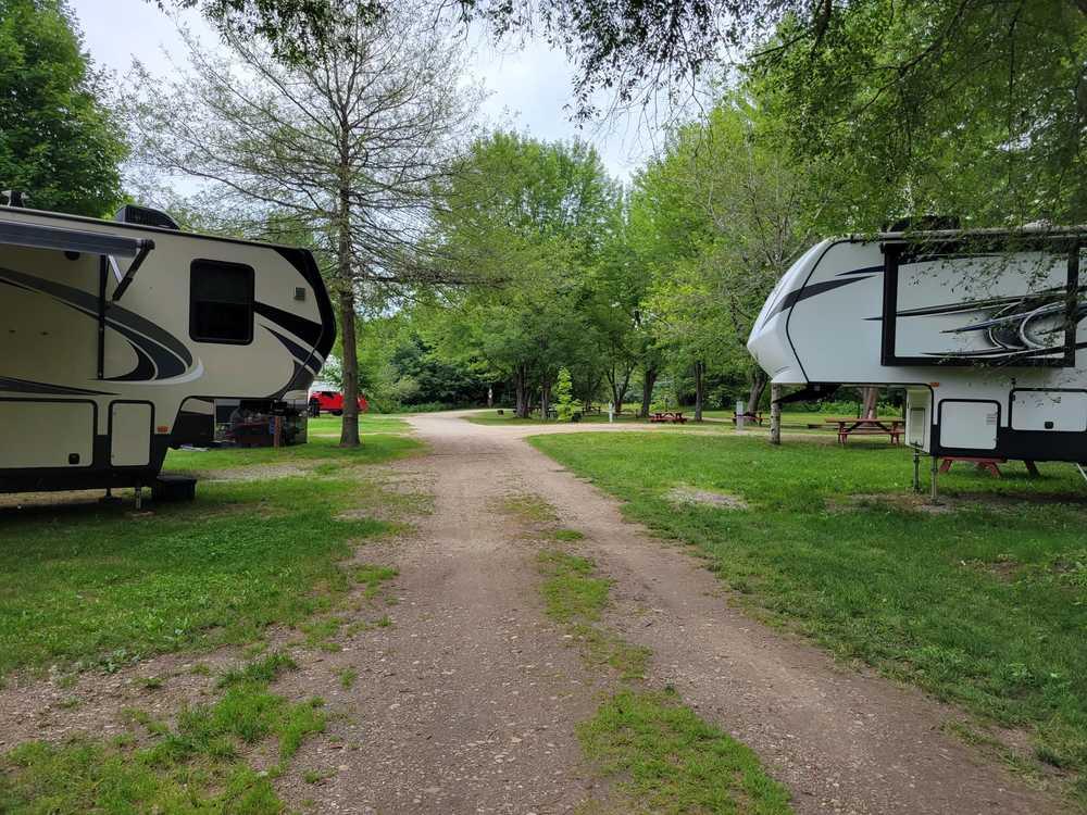 RV campground with fifth wheels and travel trailers surrounded by trees in the San Juan Islands region of Washington State.