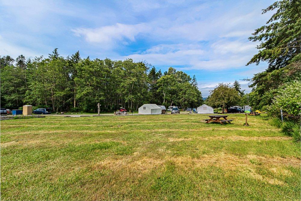 Open RV campground and camping area in the San Juan Islands with grassy campsites and forest surroundings in Washington State.