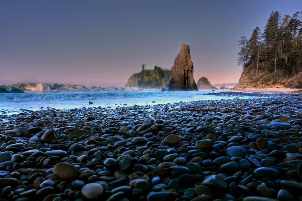 Rocky beach and sea stacks along the Olympic Peninsula coastline in Washington State during sunset, a scenic destination for RV camping and Pacific Northwest adventures.